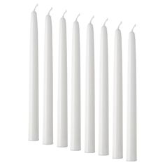 six white candles lined up in a row