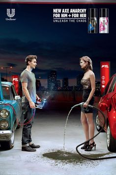 a man and woman are standing in front of a car with a hose attached to it