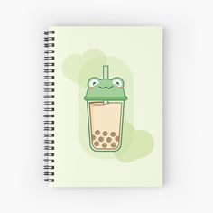 a spiral notebook with an image of a drink in the shape of a frog's head