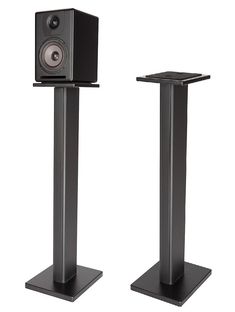 two black speakers sitting on top of each other in front of a white background,