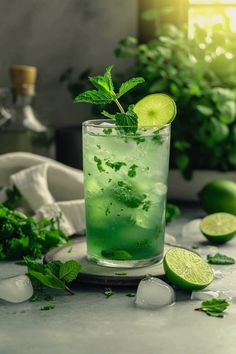 a green drink with limes and mint on the side