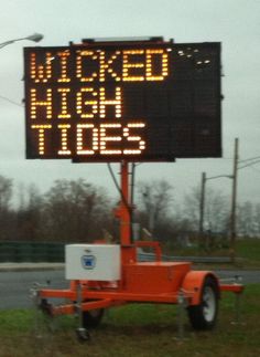 an electronic sign that reads, woke high tides