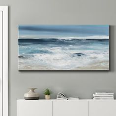 an ocean scene with waves crashing on the shore and blue sky above it, framed in white