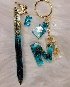 a pen, keychain, and other items are laying on a fur surface