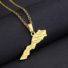 a gold necklace with the map of jamaica on it