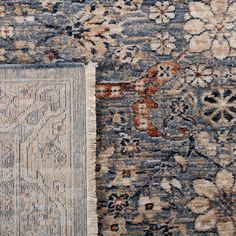 two rugs with different colors and patterns on the floor, one in blue and beige