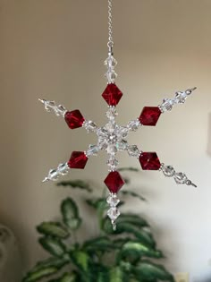 a snowflake ornament hanging from a tree