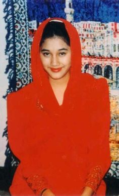 an old photo of a woman wearing a red shawl and smiling at the camera