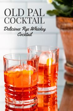 two glasses filled with old pail cocktail on top of a table