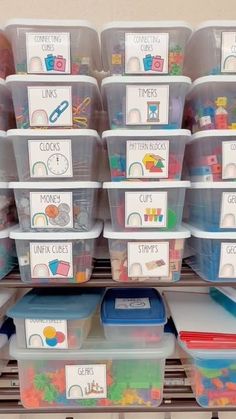 several plastic bins filled with different types of toys and letters on the bottom shelf