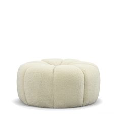 a white poufce ottoman sitting on top of a floor