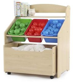 a wooden toy storage unit with three trays filled with plastic balls and other toys