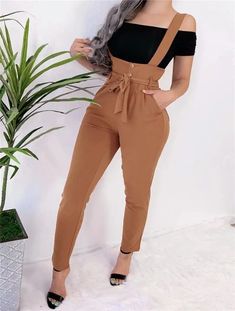 Smooth, likely synthetic material Monochrome black color Buttoned high-waist design Overalls-style jumpsuit Casual or chic occasions Pair with fitted tops Style Salopette, Bandage Design, Celana Fashion, Strap Pants, Casual Pants Style, Jumpsuit Casual, Slim Hips, Suspenders For Women, Overall Jumpsuit