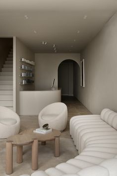 a living room filled with white couches and tables