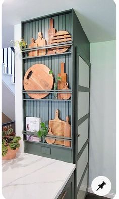 a shelf with cutting boards and other kitchen utensils