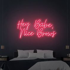 there is a neon sign that says hey babe, nice browss on the wall