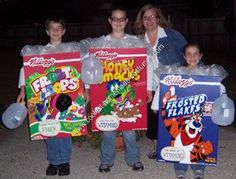 three people holding up two large candy boxes and one small child in front of them