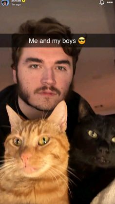 a man is looking at the camera with two cats on his chest and one cat sitting next to him