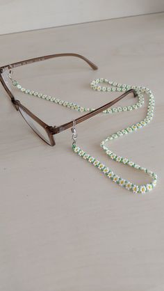 Never lose your glasses again!... As a jewelry lover and designer I've always believed that eyeglass leash should be designed as a beautiful piece of beaded jewelry. This fancy and stylish eyeglass chain fits snugly around the ends of your glasses and drapes around your neck for optional, all-day comfortable wear. Also, this eyeglass chain can be a gift for MOTHER'S DAY as well! :) Beads Eyeglass Chain, Glasses Chain Diy Beads, Glasses Band Diy, Daisy Chain Jewelry, Diy Beaded Glasses Chain, Pearl Glasses Chain, Glasses Accessories Chain, Glasses Strap Beads, Adjustable Flower Glass Jewelry