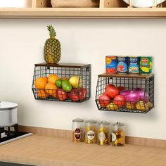 two metal baskets filled with fruit on top of a kitchen counter