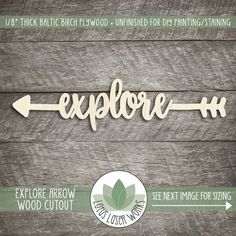 the word explore is cut out from wood and placed on a wooden surface with an arrow