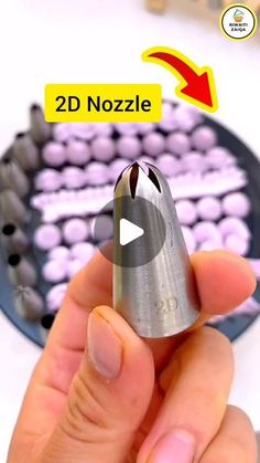 a person holding a metal object in their hand with the words 3d nozzle on it