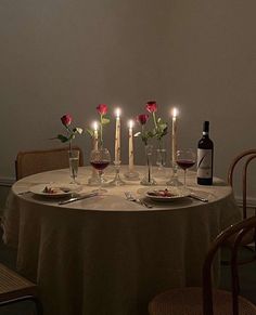 the table is set with wine and candles