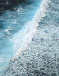 an aerial view of the ocean with waves