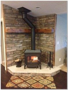 a wood burning stove sitting inside of a living room next to a wall with shelves