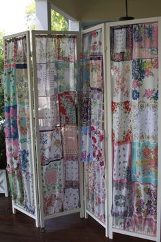 an open room divider covered in colorful fabric