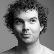 a black and white photo of a man with curly hair