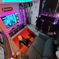 a living room filled with furniture and a flat screen tv on top of a wall