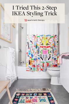 a bathroom with a rug on the floor and a shower curtain in the background that says, i tried this 2 - step ikea styling trick