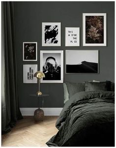 a bedroom with dark green walls and pictures on the wall above it, along with a bed