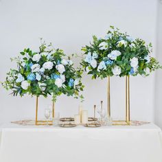 two vases filled with flowers on top of a table