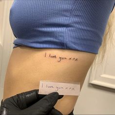 a woman's stomach with a piece of paper that says i love you next to it