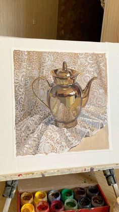 an oil painting of a teapot on a table with paintbrushes next to it