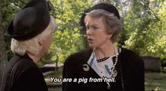 two women talking to each other in front of trees with the caption you are a pig from hell