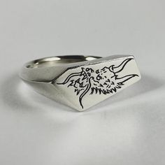 All “Ryujin” signet rings are made to order please allow 2-4 weeks production time. Ryujin the Japanese dragon god of the sea. Each design is hand carved by us and made using the "lost wax" technique. Carved, cast and finished in Australia. Material - Solid 100% Recycled Sterling Silver Face Size - 1.8 x 0.9cm Band tapers to 3.5mm Hallmarks -"DI" (Dead Ivy) & "925" (Sterling Silver) Gem Stone: 2mm lab grown Ruby or Blue Sapphire Unless requested gem stone will be flush set into same area as shown in product photos. Different placement and stones are available upon request. Men’s Silver Rings, Japanese Tattoo Flash, Dragon God, Hand Carved Jewelry, Cool Rings For Men, Japanese Dragon, Signet Rings, Silver Signet Ring, Wax Casting