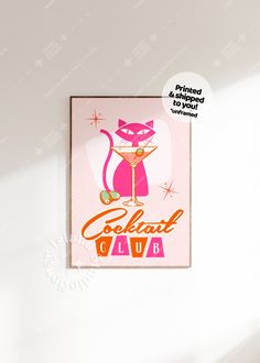 a pink card with an image of a cat holding a martini glass