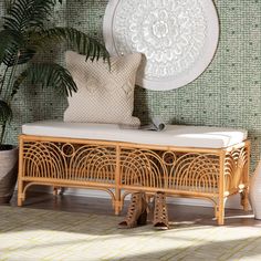 a wooden bench sitting in front of a wall with a plant on top of it