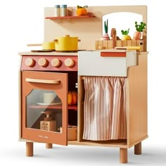 a wooden toy kitchen with an oven and sink