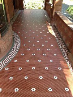 a red and white tiled walkway in front of a building