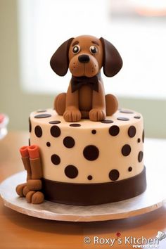 a cake decorated with a dog sitting on top of a polka dot covered cake plate