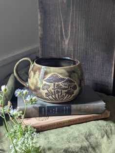 two books and a vase on top of each other