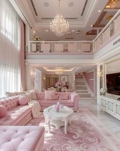 a living room filled with pink furniture and a chandelier hanging from the ceiling