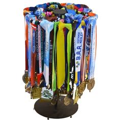 a bunch of medals that are sitting on a stand in front of a white background