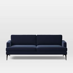 a blue couch sitting on top of a white floor