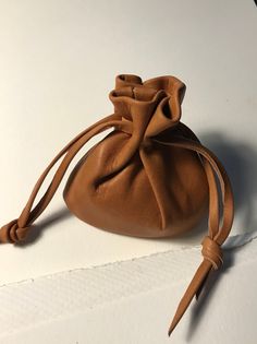 a small brown bag sitting on top of a white table