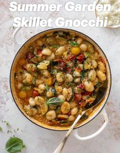 a skillet filled with gnocchi sauce and garnished with fresh herbs